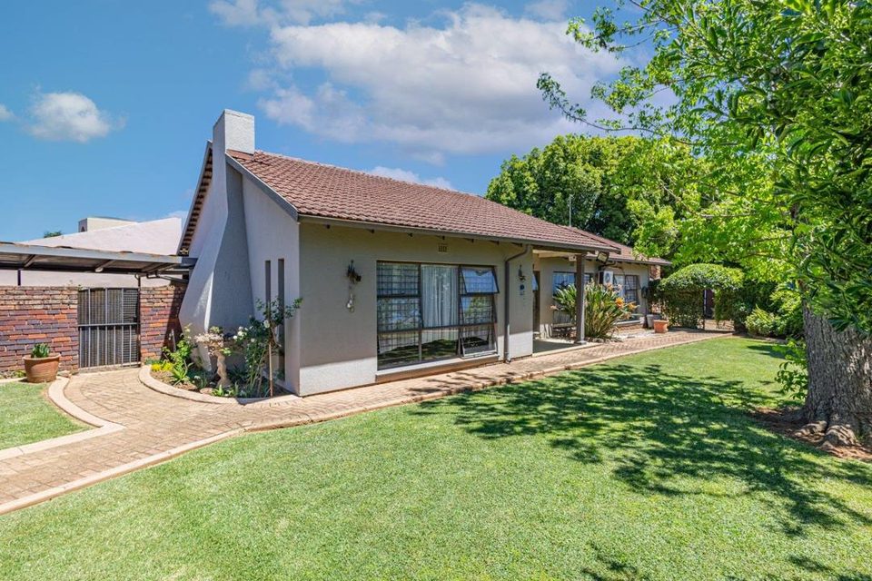 Farrarmere home with paved driveway, lawn and tiled roof