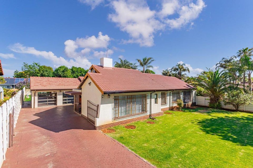 Farrarmere family home with paved driveway, lawn and double garage